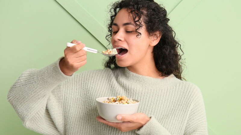 Person eating cereal from a bowl