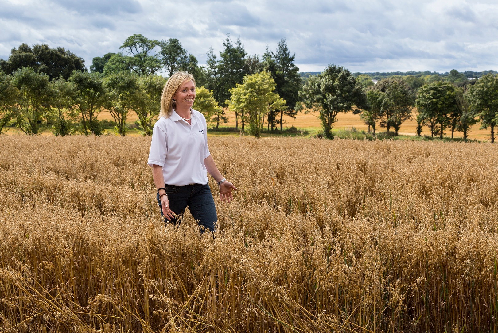 a woman walking through a field of corn