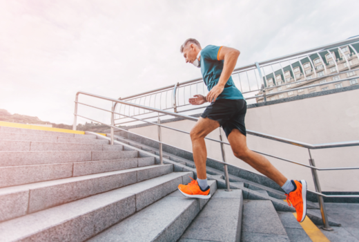 a man in fitness clothes running up steps