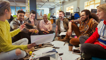 group of people sitting around a table discussing