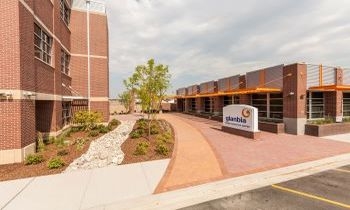 a woman in a white lab coat and lab glasses testing samples