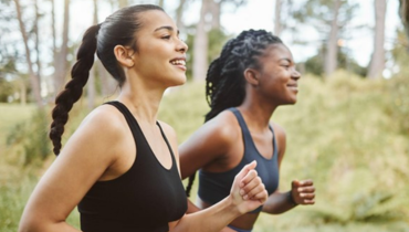 two women on a run in the woods in black tank tops