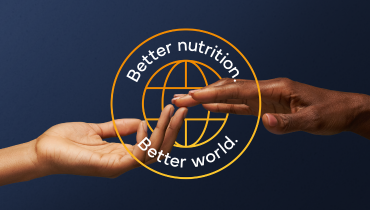 two hands touching, better nutrition, better world text