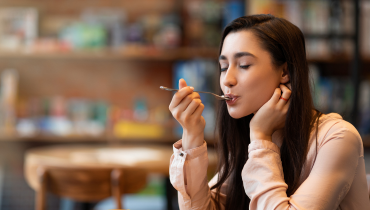 girl tasting something on a spoon