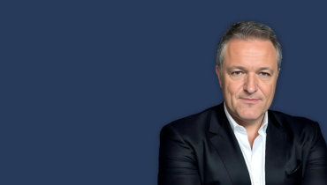 man wearing a suit on a navy background