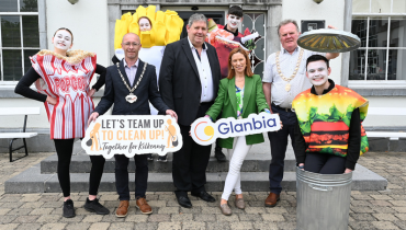 group of people holding signs and dressed up in food costumes