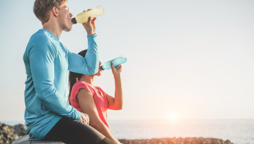 man drinking yellow drink, woman drinking blue drink
