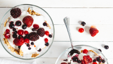 two bowls of granola topped with yogurt and granola