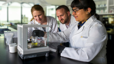 three people working in a lab