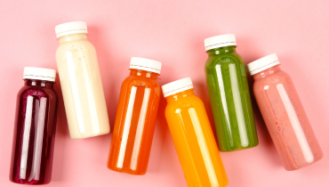 variety of coloured drinks in plastic bottles