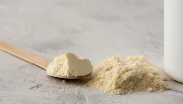 scoop of powder on a wooden spoon