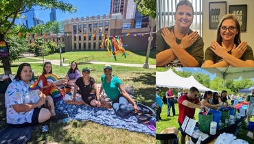 group of people sitting down on grass with pride flags 