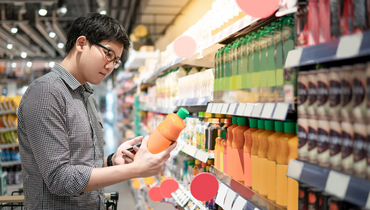 man selecting drink in a supermarket