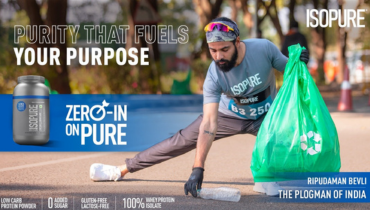 man picking up litter in India, isopure bottle