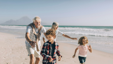 family running on a beach