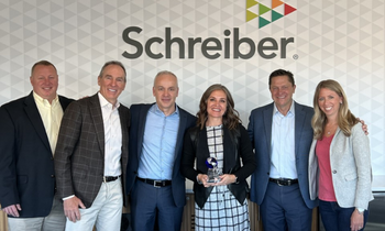 group of people holding a supplier of the year award