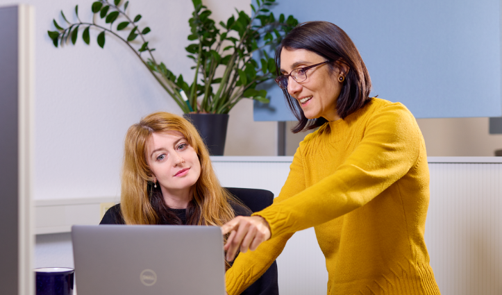 two people looking at laptop screen