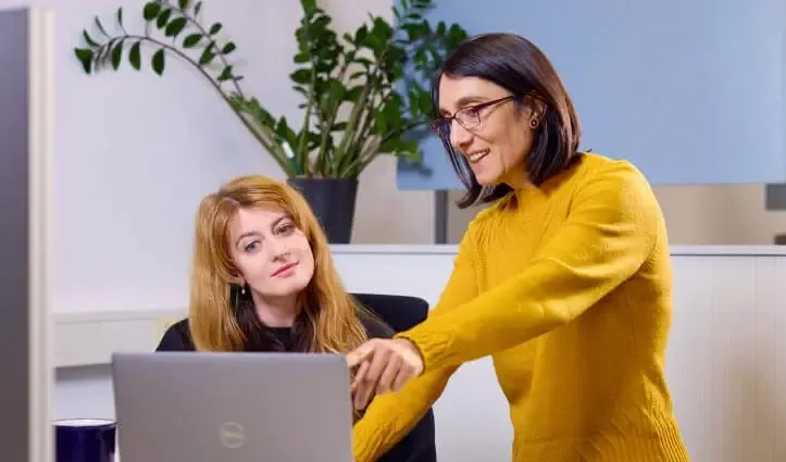 two people looking at laptop screen