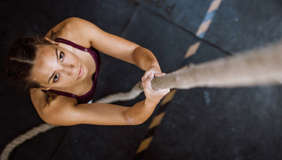 a woman climbing a rope