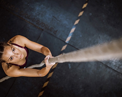 a woman climbing a rope