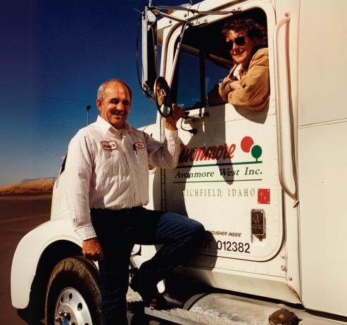 man holding on to the side on an avonmore truck