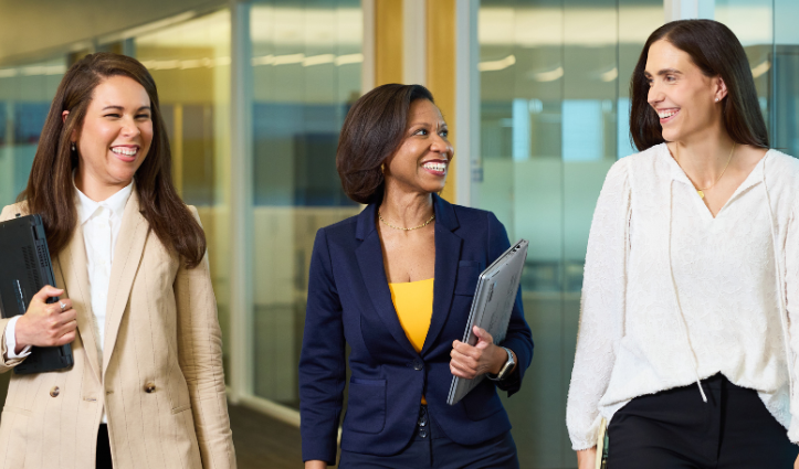 three women walking down a hall