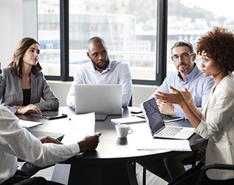 a group of people around a table in a discussion
