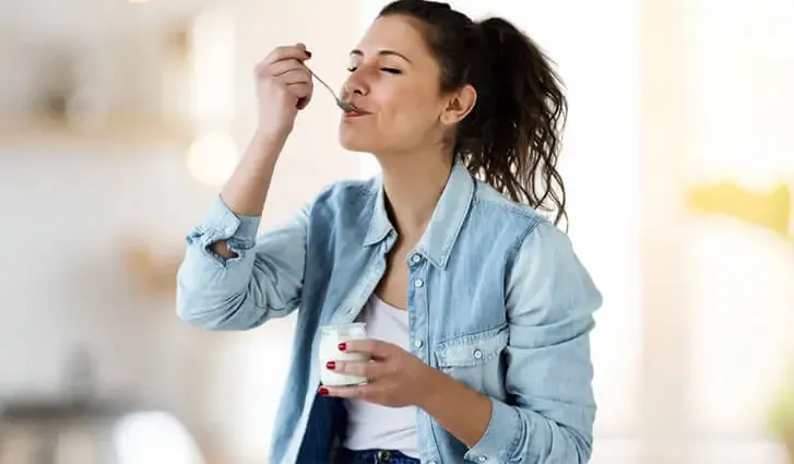 woman eating yogurt
