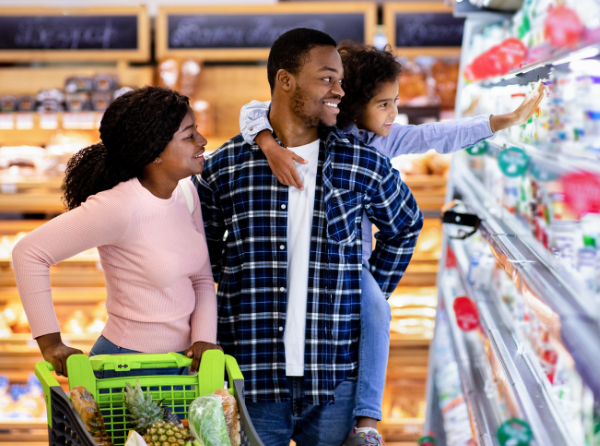 family walking down aisle of a supermarket