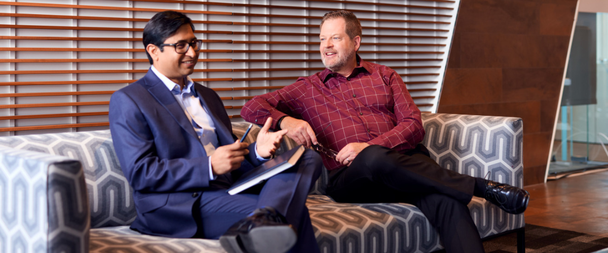 two employees at Glanbia talking on a couch