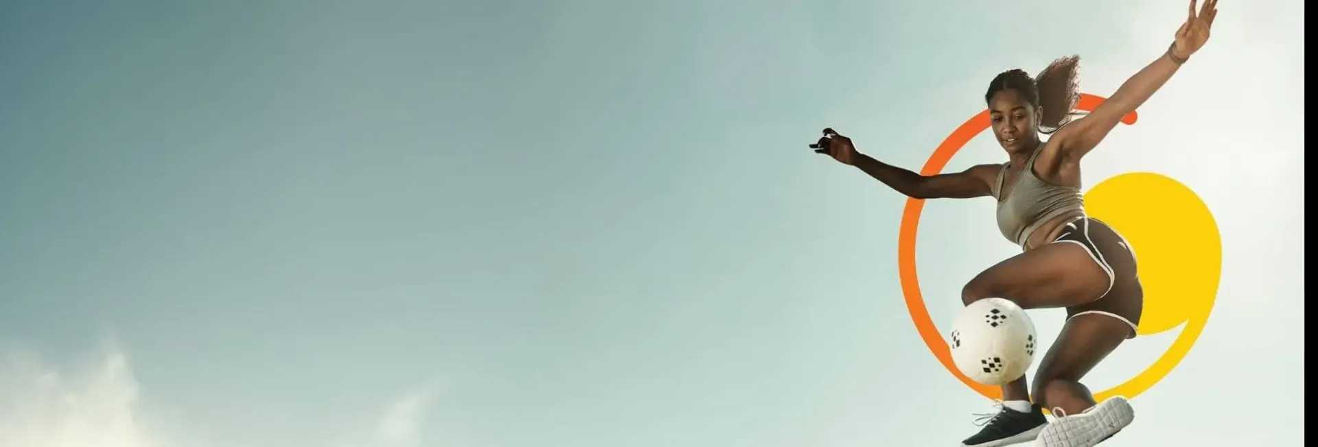 A person performing a mid-air soccer kick against a clear sky with colorful graphic elements behind them.