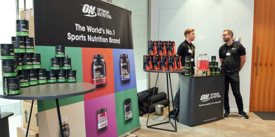 optimum nutrition, two people standing