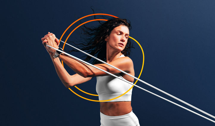 Woman working out with a resistance band - Glanbia logo in background