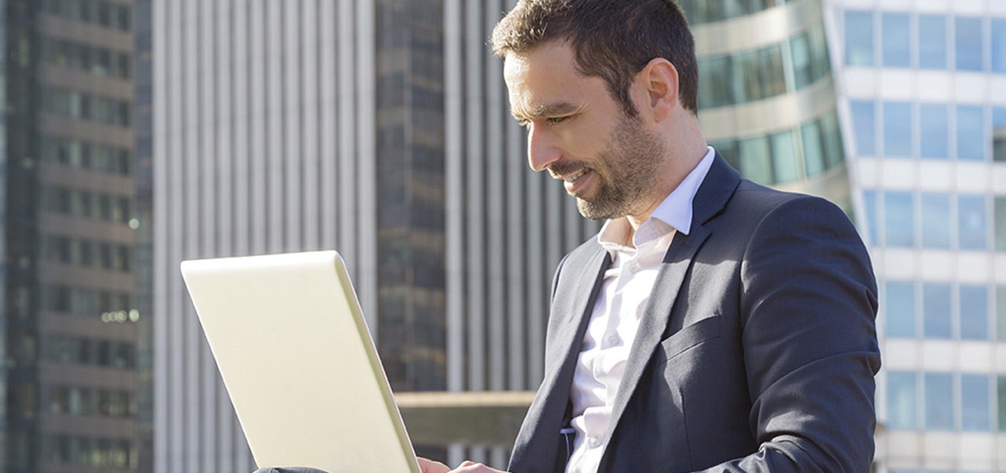 a man looking at a laptop screen