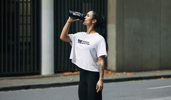 woman with optimum nutrition drink