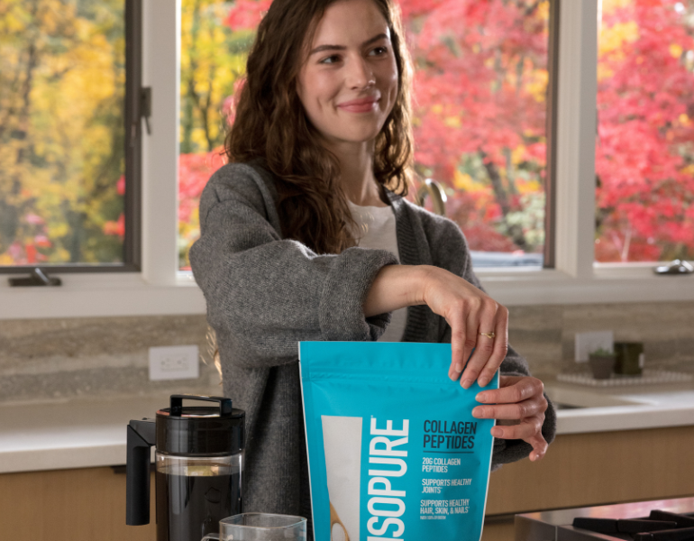 woman ripping open a packet of ISOPURE Collagen