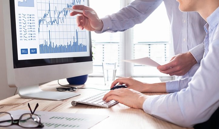 people looking at graphs on a computer screen