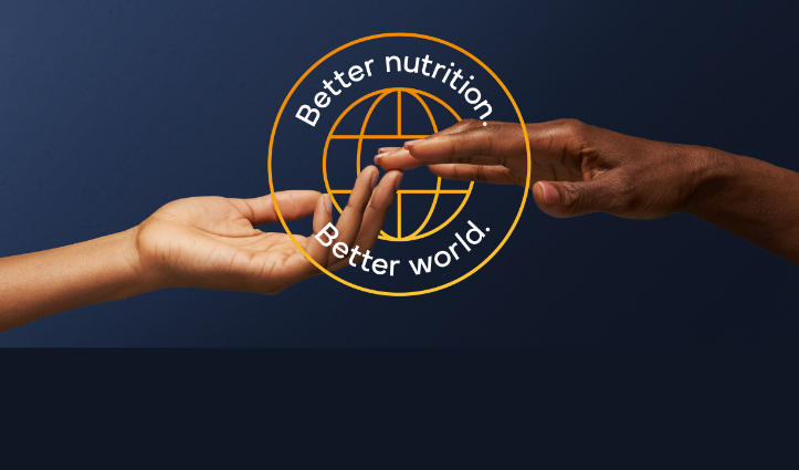 two hands touching with better nutrition, better world text