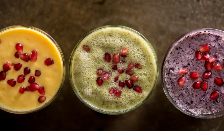 3 healthy smoothies in a glasses with seeds sprinkled on top