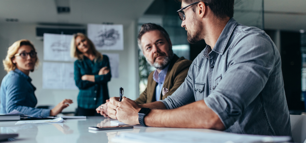 group of people sat around a table discussing