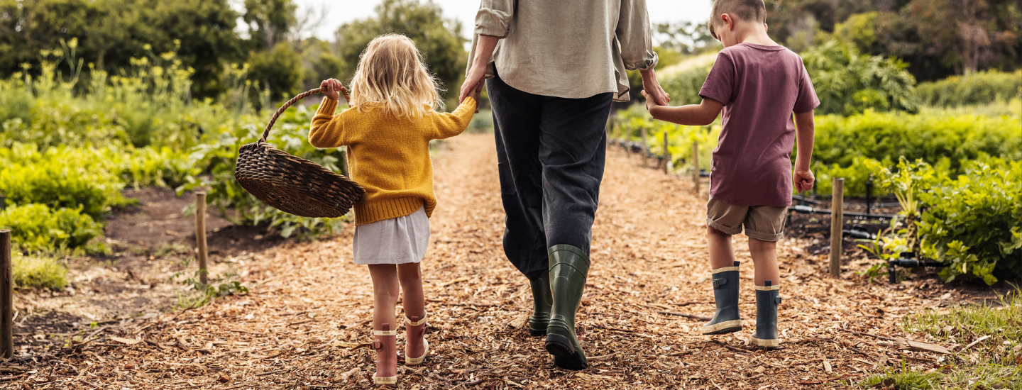 Adult and children walking holding hands