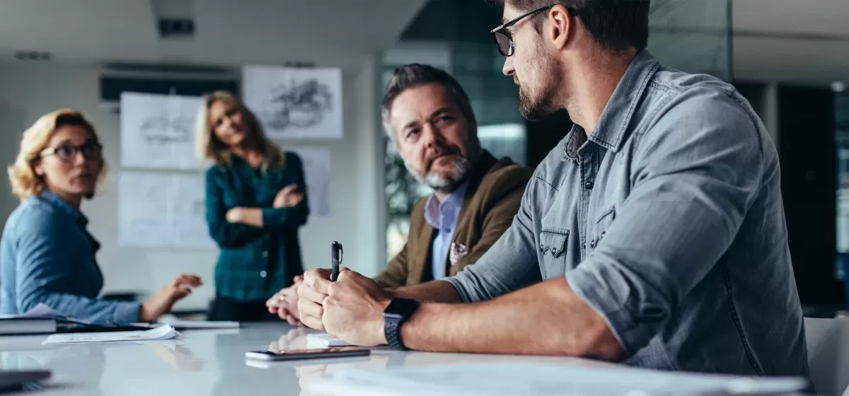 people sat around a table discussing