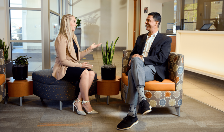 man and woman sat down discussing