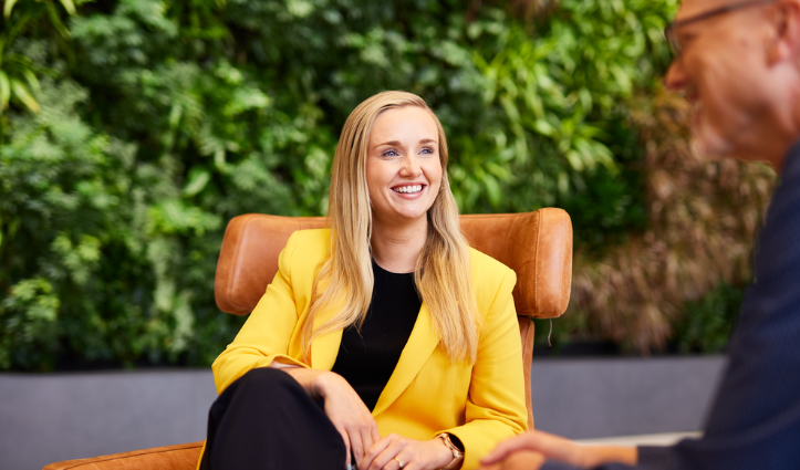 woman wearing yellow jacket sitting in a chair