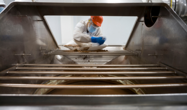 man working inside a machine in a factory