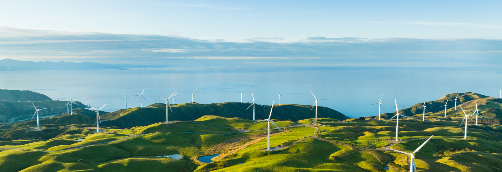 blue sky, sea, windmills, hills