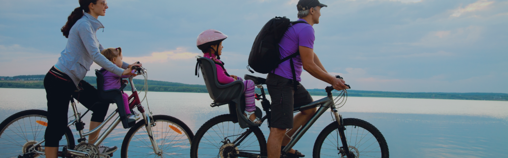 woman and man cycling on bicycles with a child each on bikes