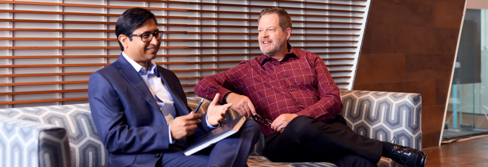 2 people discussing on a couch