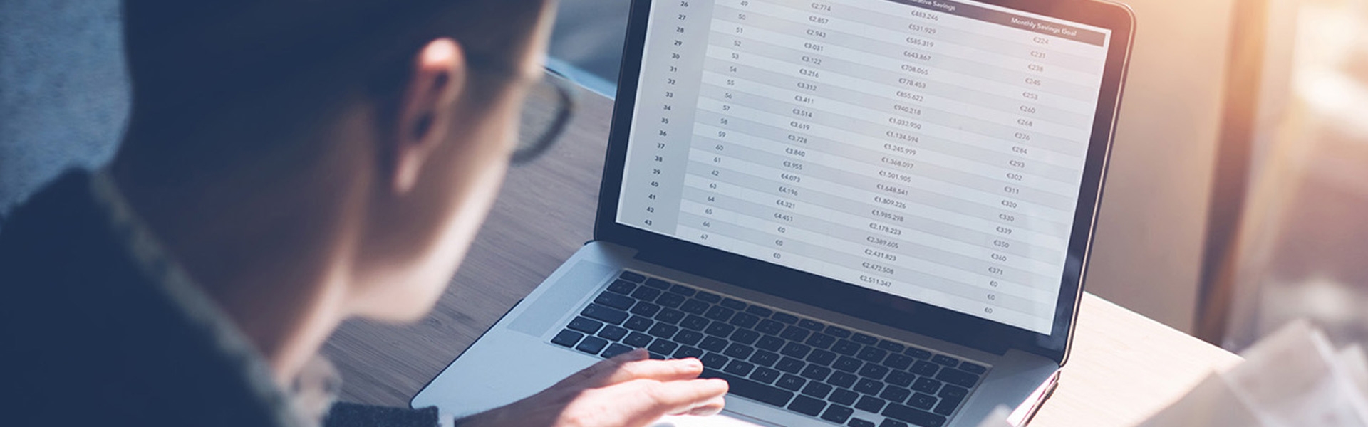 A man looking at a laptop screen typing