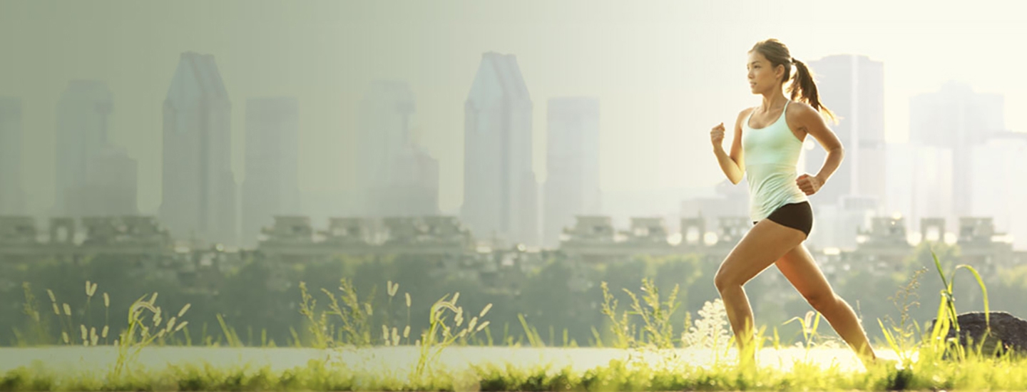 a woman running with the city in the background
